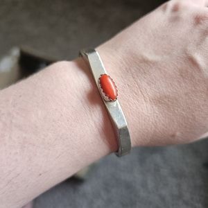 Signed coral cuff bracelet. 5 inches with a 1 1/2 inch gap currently. Has some f